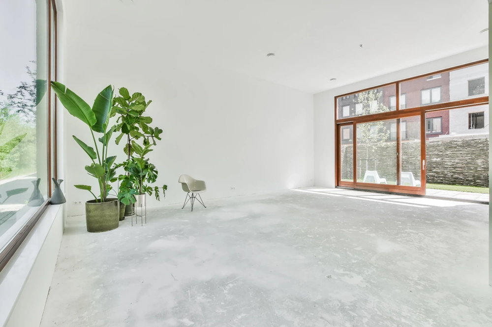 Przestronne, jasne wnętrze z gładką wylewką betonową i dużymi przeszkleniami